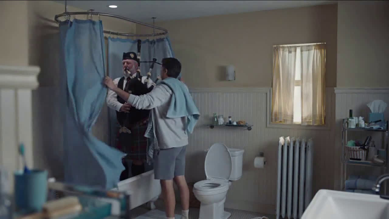  Man playing the bagpipes in the kitchen