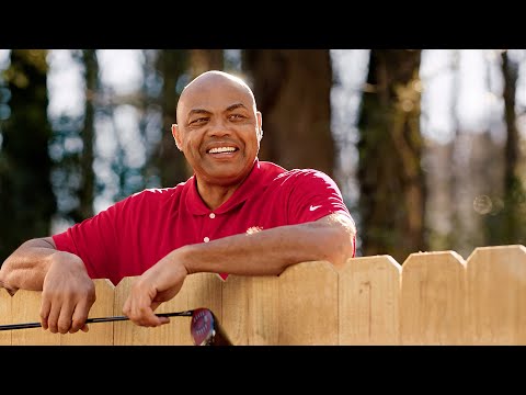  Charles Barkley appears on top of the fence waving to his neighbors.