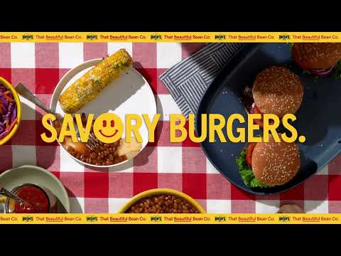  Man eating a hamburger with cooked beans