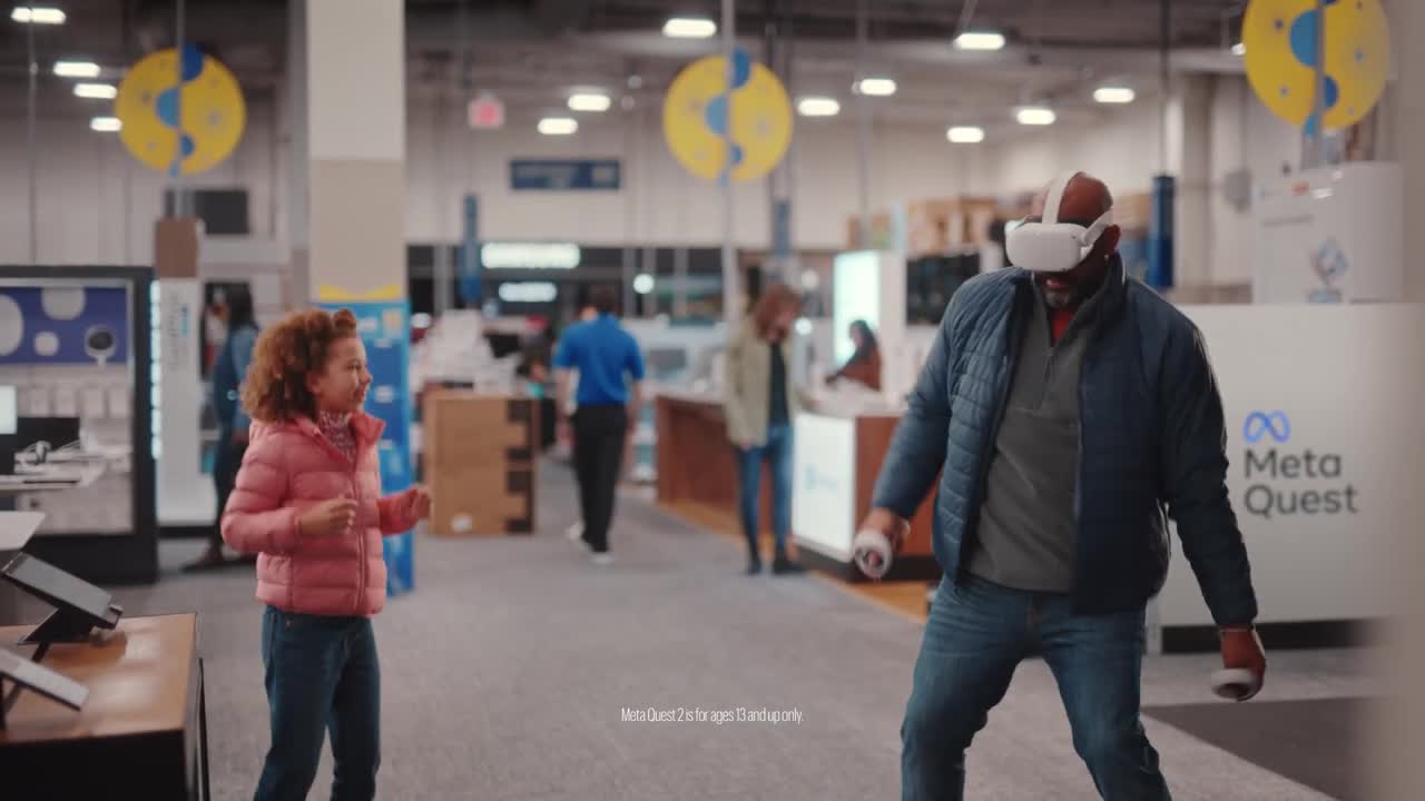  Father and daughter trying out the games at Best Buy