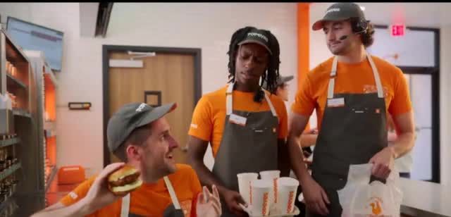  man uses a hamburger as a telephone