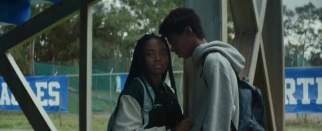  Two students look at each other's faces as they see a hole in the ground