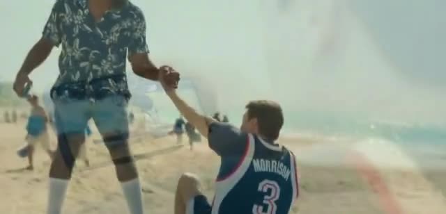 AT&T Man watching a basketball game on the beach