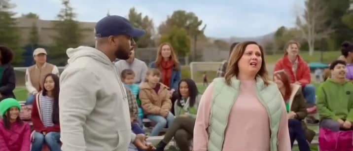 T-Mobile Man watching Apple TV while his son plays