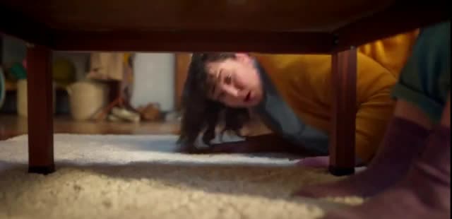  woman looks under the table