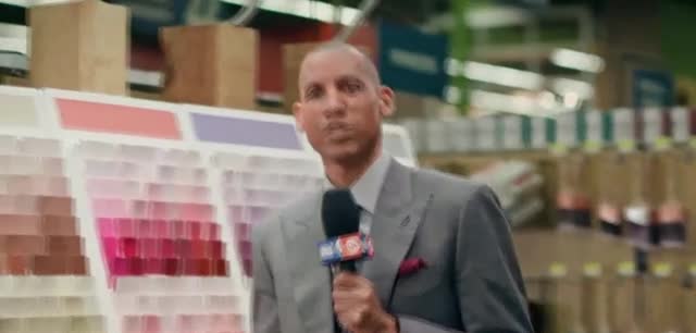 State Farm Woman comparing color with a wall of colors