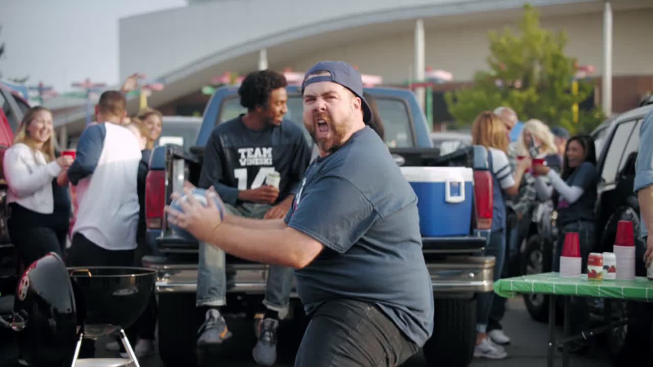  people in football suits dance with their canned wines