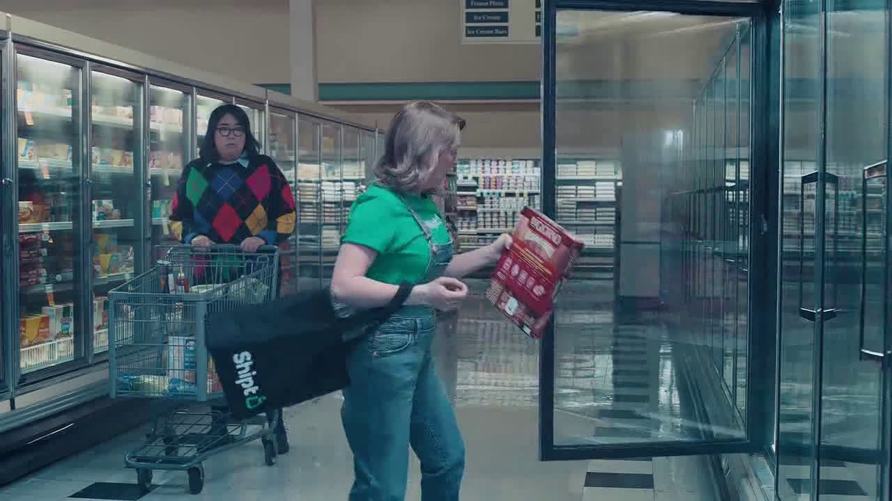  girl in a plaid sweater in the shop