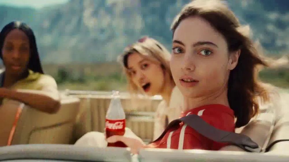 Who sings in the Coca-Cola Share a Summer campaign ad?